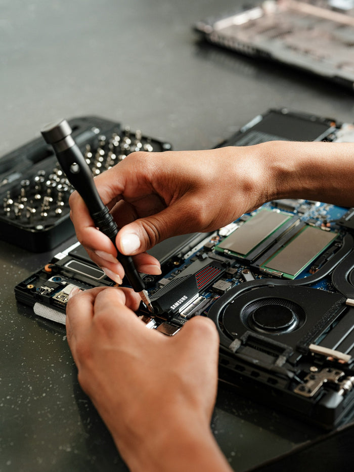 Technician working on electronics hardware, Starlink warranty and repairs in the UAE