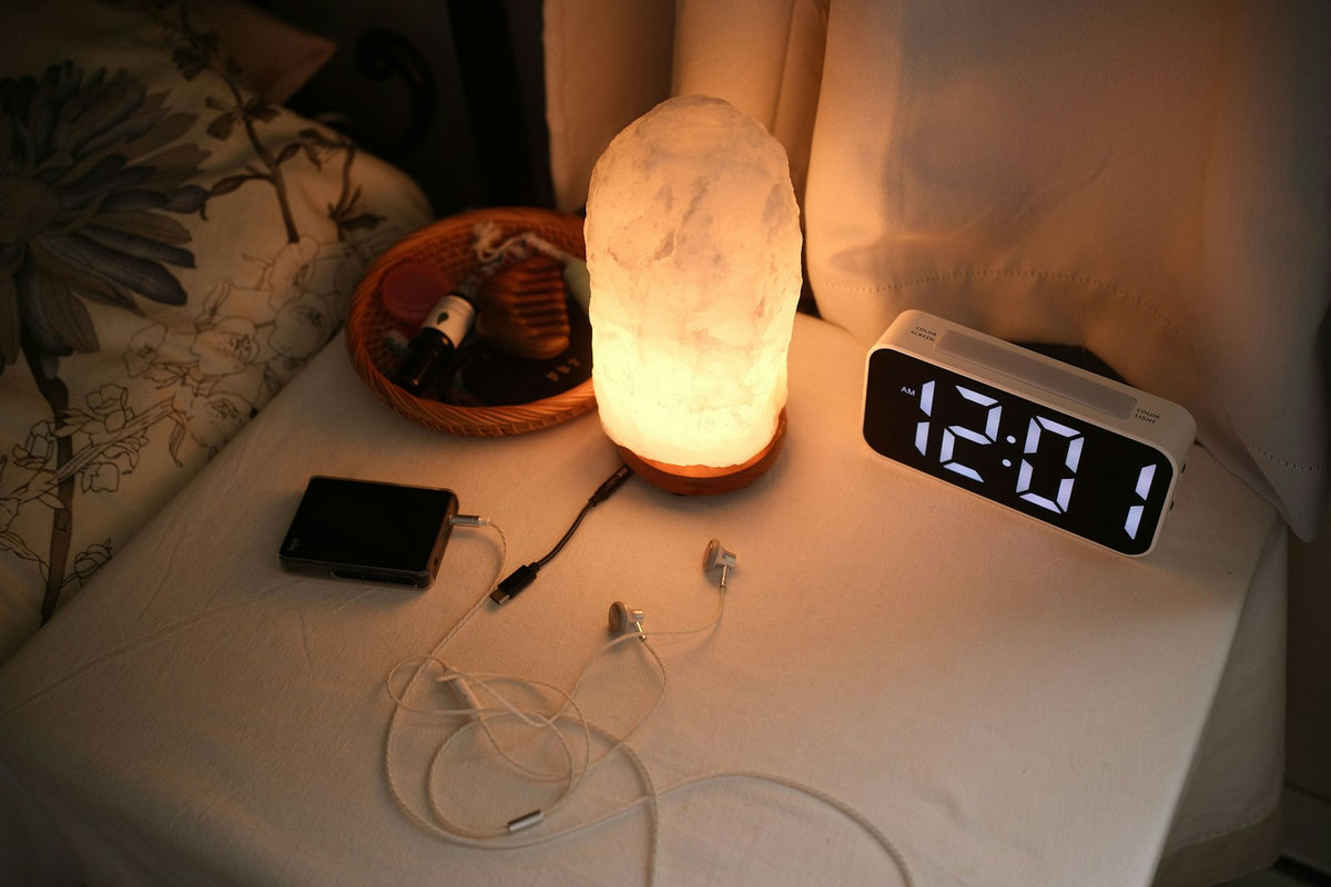 Bedside nightstand with a lamp, clock and chargers – a simple charging routine for the Fitbit Air